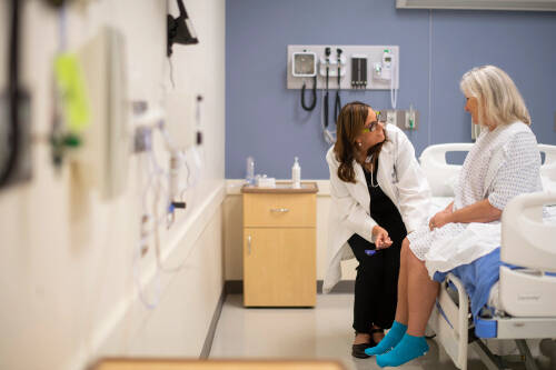 student speaks with volunteer patient